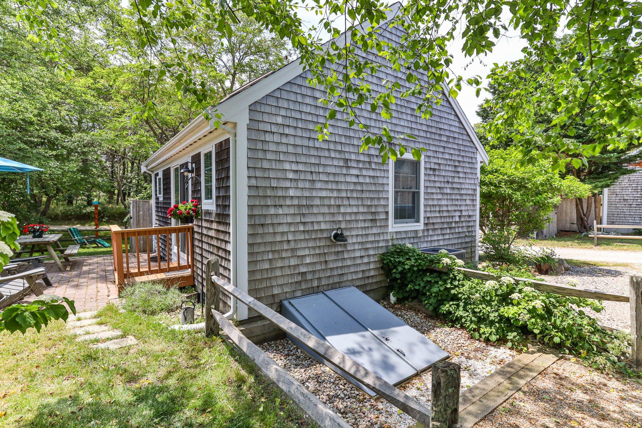 6 Shore Road, Unit 10 Truro, MA 02666 - Photo 24 of 37 a backyard of a house with outdoor seating