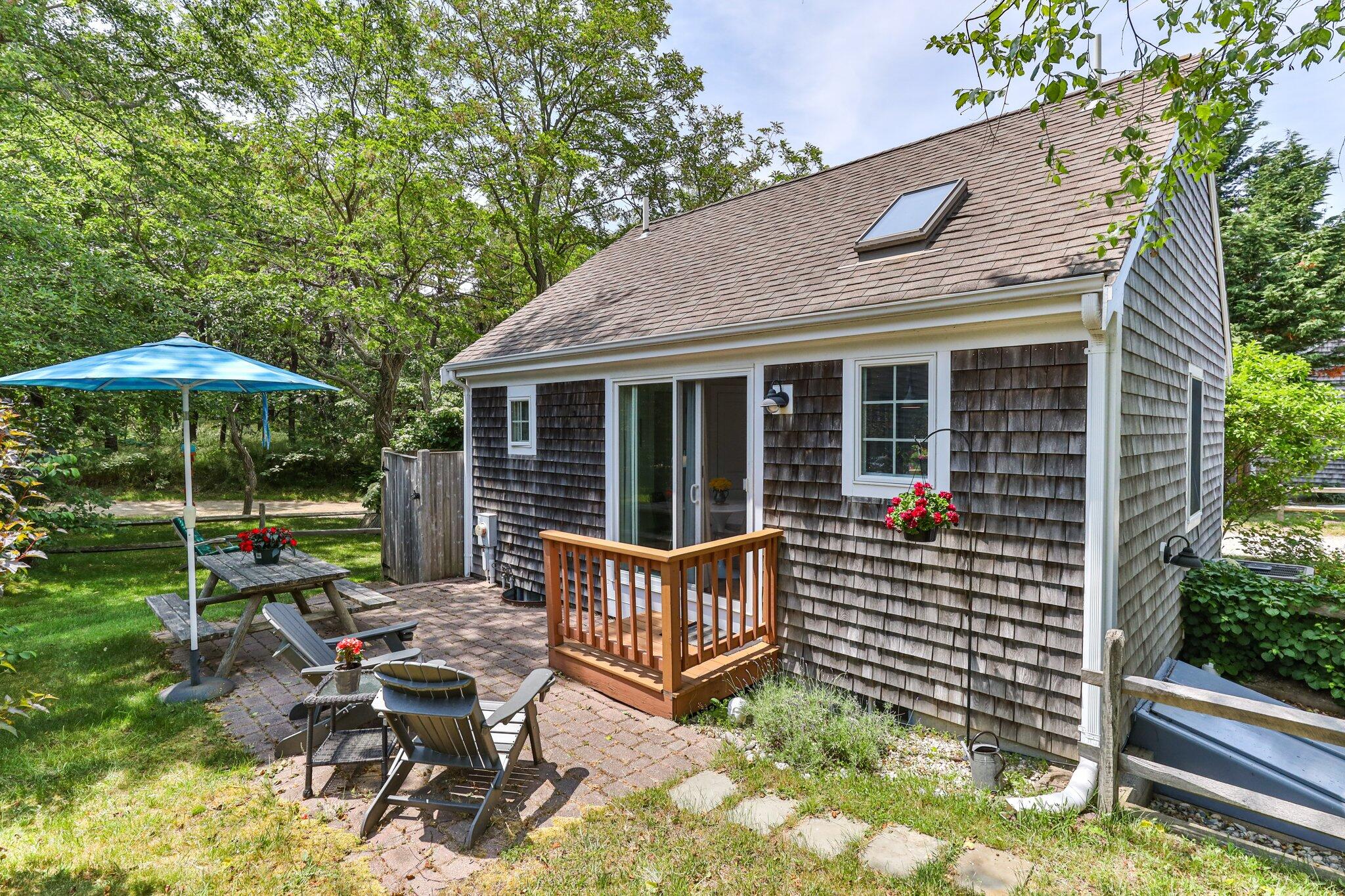 6 Shore Road, Unit 10 Truro, MA 02666 - Photo 25 of 37 a view of a house with backyard and sitting area