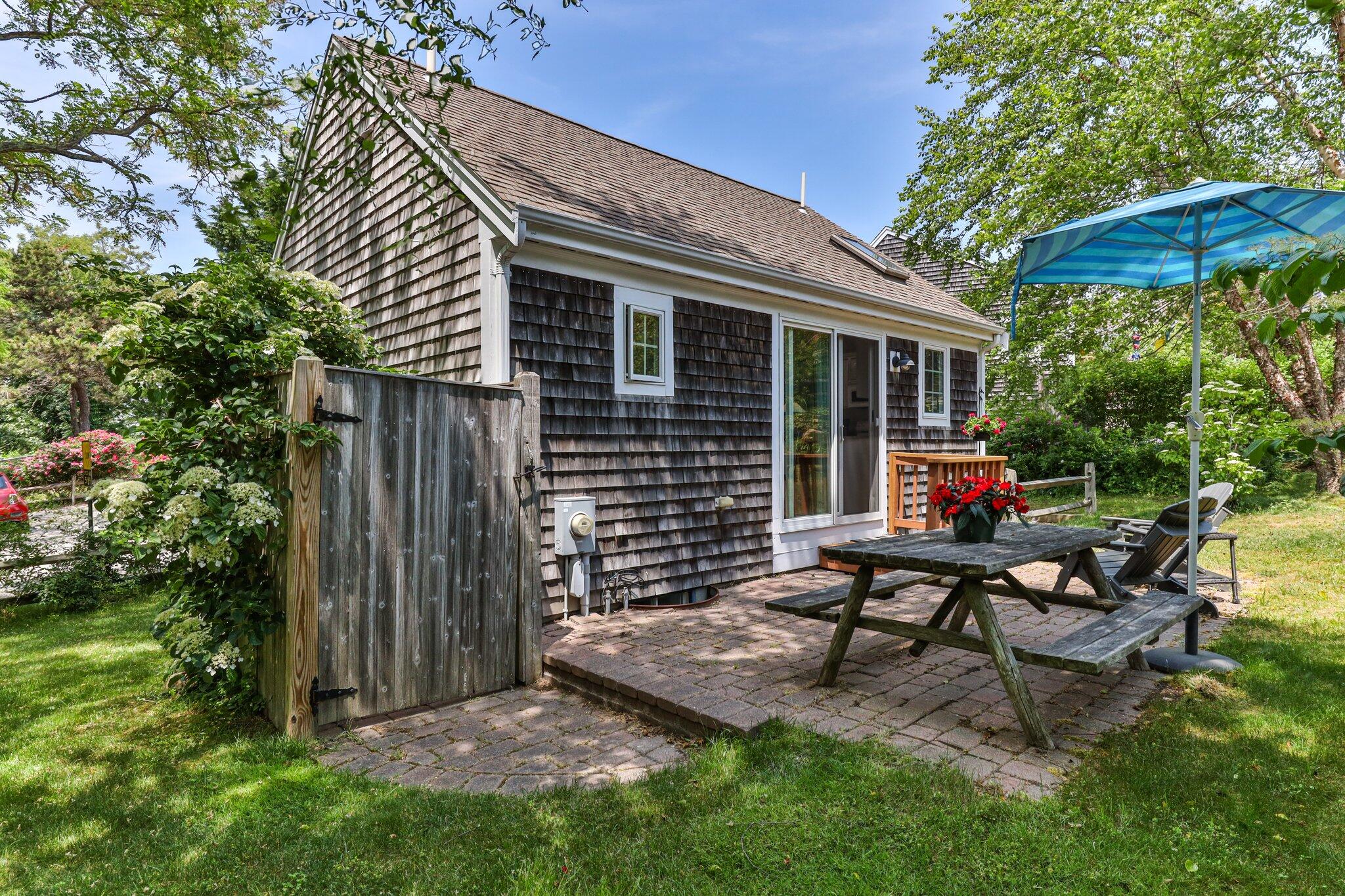 6 Shore Road, Unit 10 Truro, MA 02666 - Photo 28 of 37 a backyard of a house with seating space