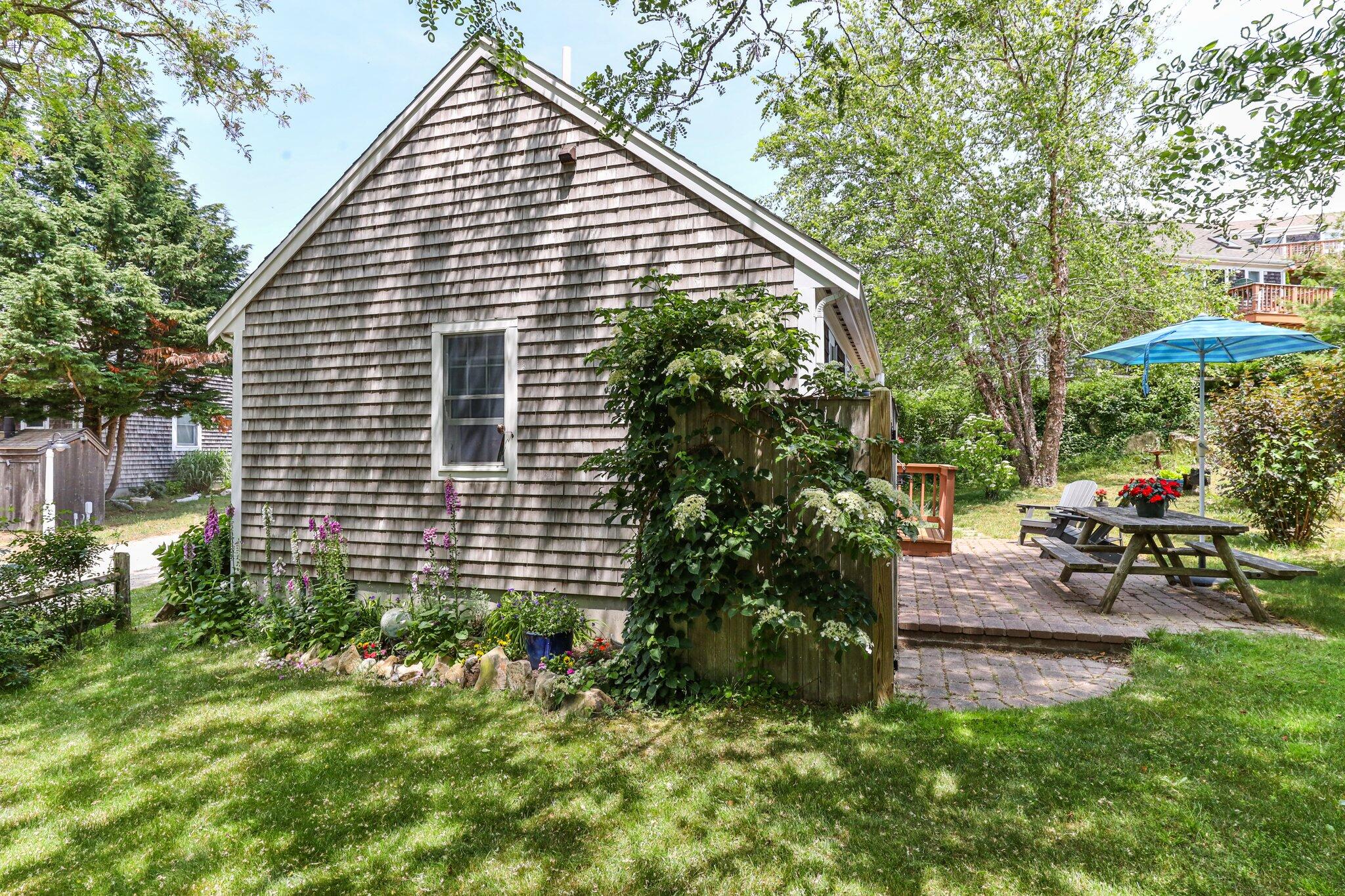 6 Shore Road, Unit 10 Truro, MA 02666 - Photo 29 of 37 a view of a house with backyard and sitting area