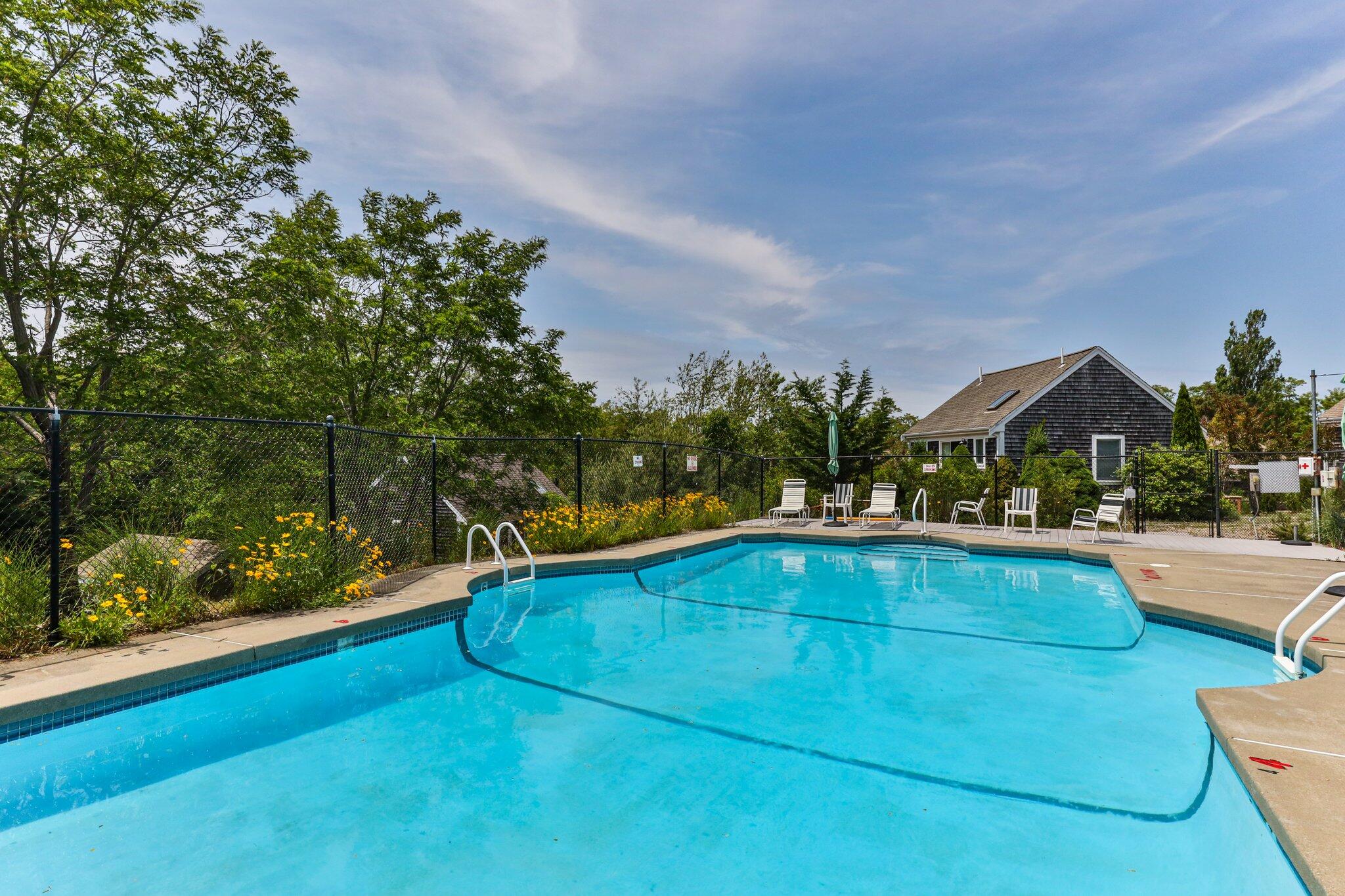 6 Shore Road, Unit 10 Truro, MA 02666 - Photo 35 of 37 a view of swimming pool with seating area and trees in the background