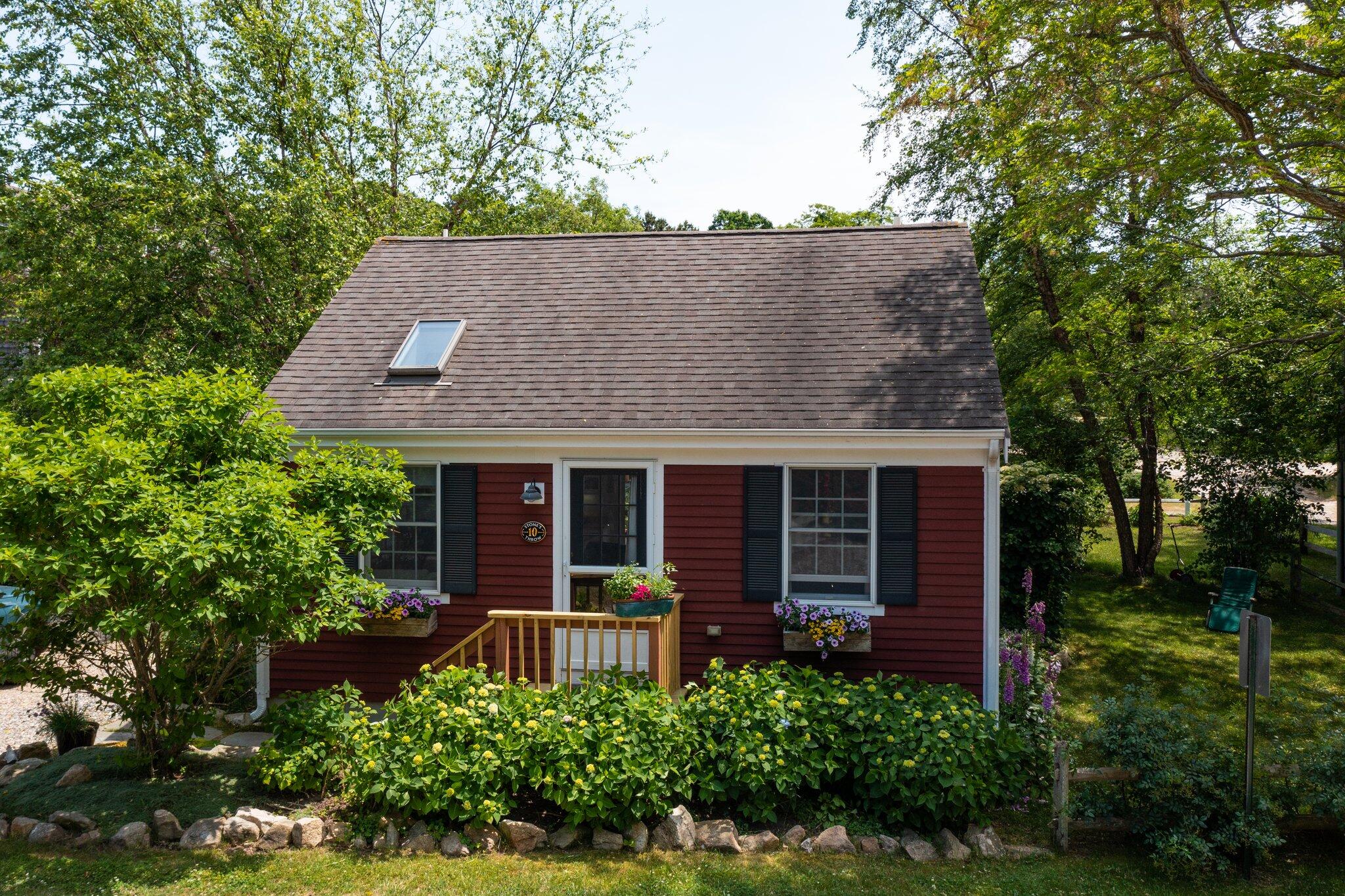 6 Shore Road, Unit 10 Truro, MA 02666 - Photo 37 of 37 front view of a house with potted plants and large trees