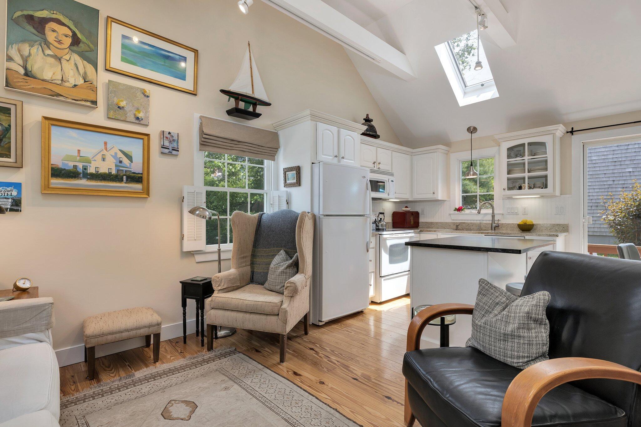 6 Shore Road, Unit 10 Truro, MA 02666 - Photo 5 of 37 a living room with furniture and a chandelier