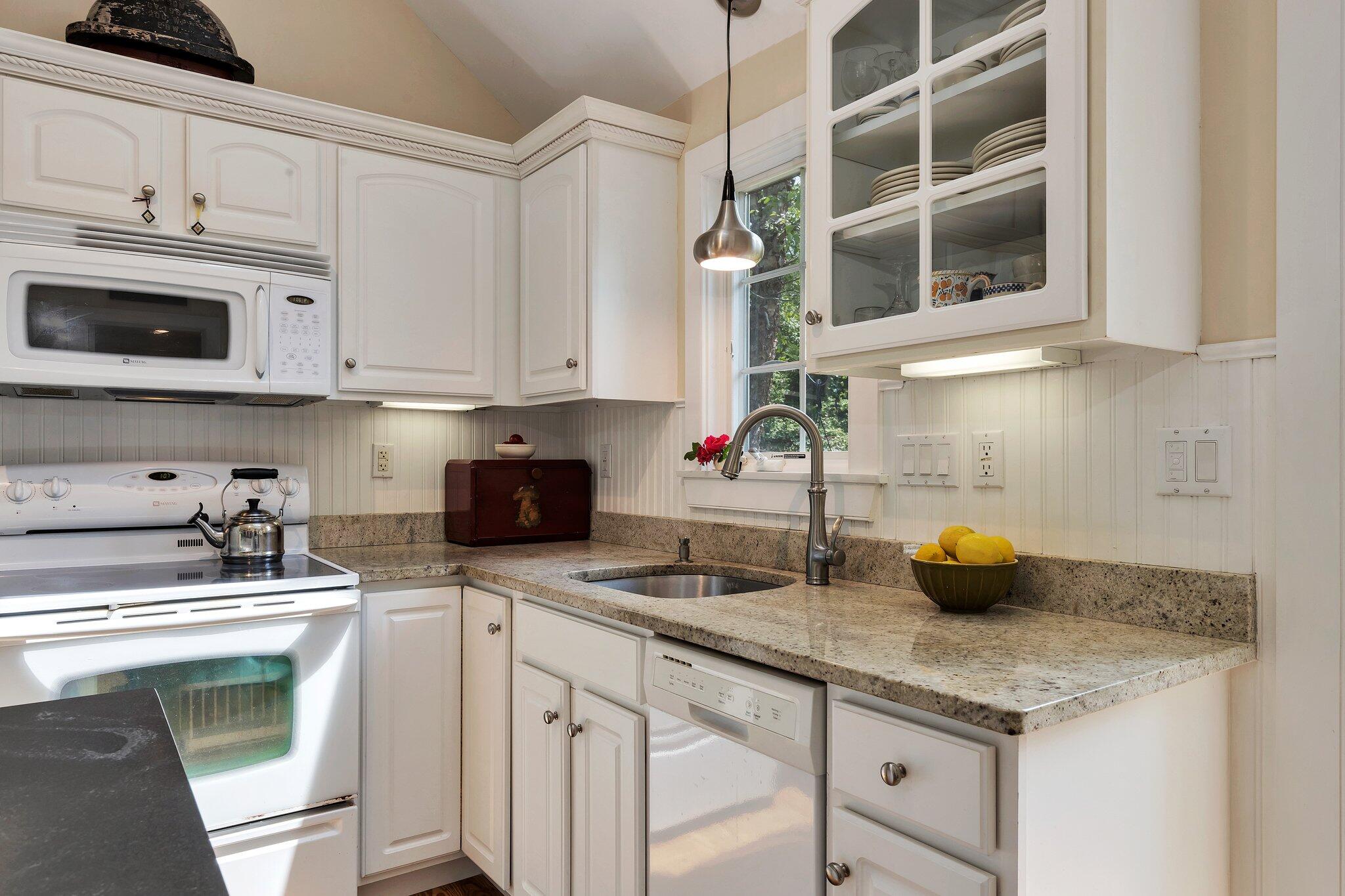 6 Shore Road, Unit 10 Truro, MA 02666 - Photo 10 of 37 a kitchen with stainless steel appliances white cabinets and a sink