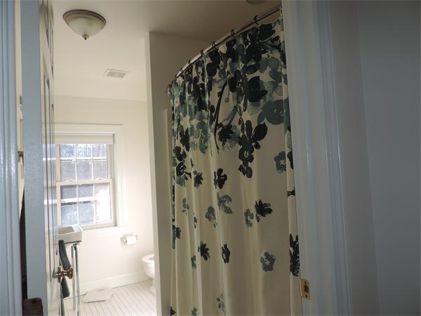 169 Islington Road Newton, MA 02466 - Photo 13 of 16 a bathroom with a bathtub and shower
