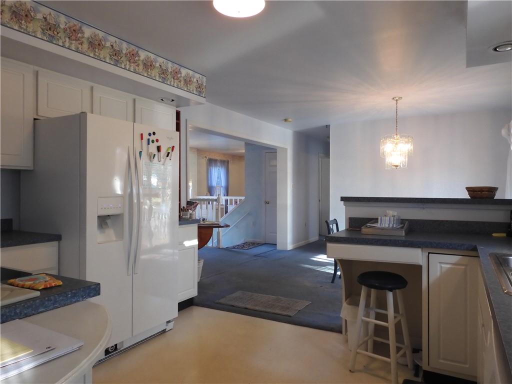 407 Oneida Trail Mercer, PA 16137 - Photo 6 of 25 a kitchen with a table chairs refrigerator and cabinets
