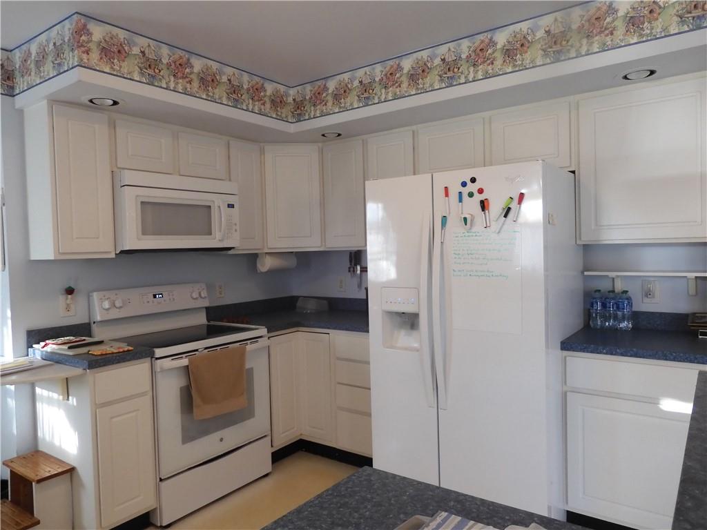 407 Oneida Trail Mercer, PA 16137 - Photo 8 of 25 a white refrigerator freezer sitting inside of a kitchen