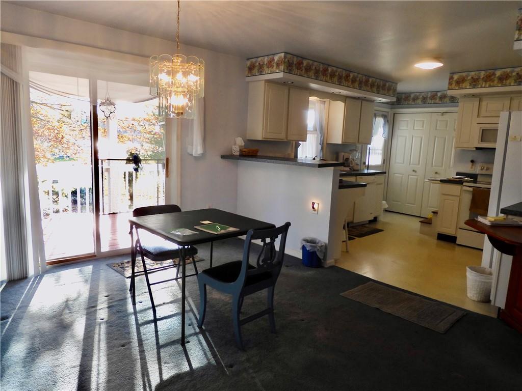 407 Oneida Trail Mercer, PA 16137 - Photo 10 of 25 a room with a table chairs and a refrigerator