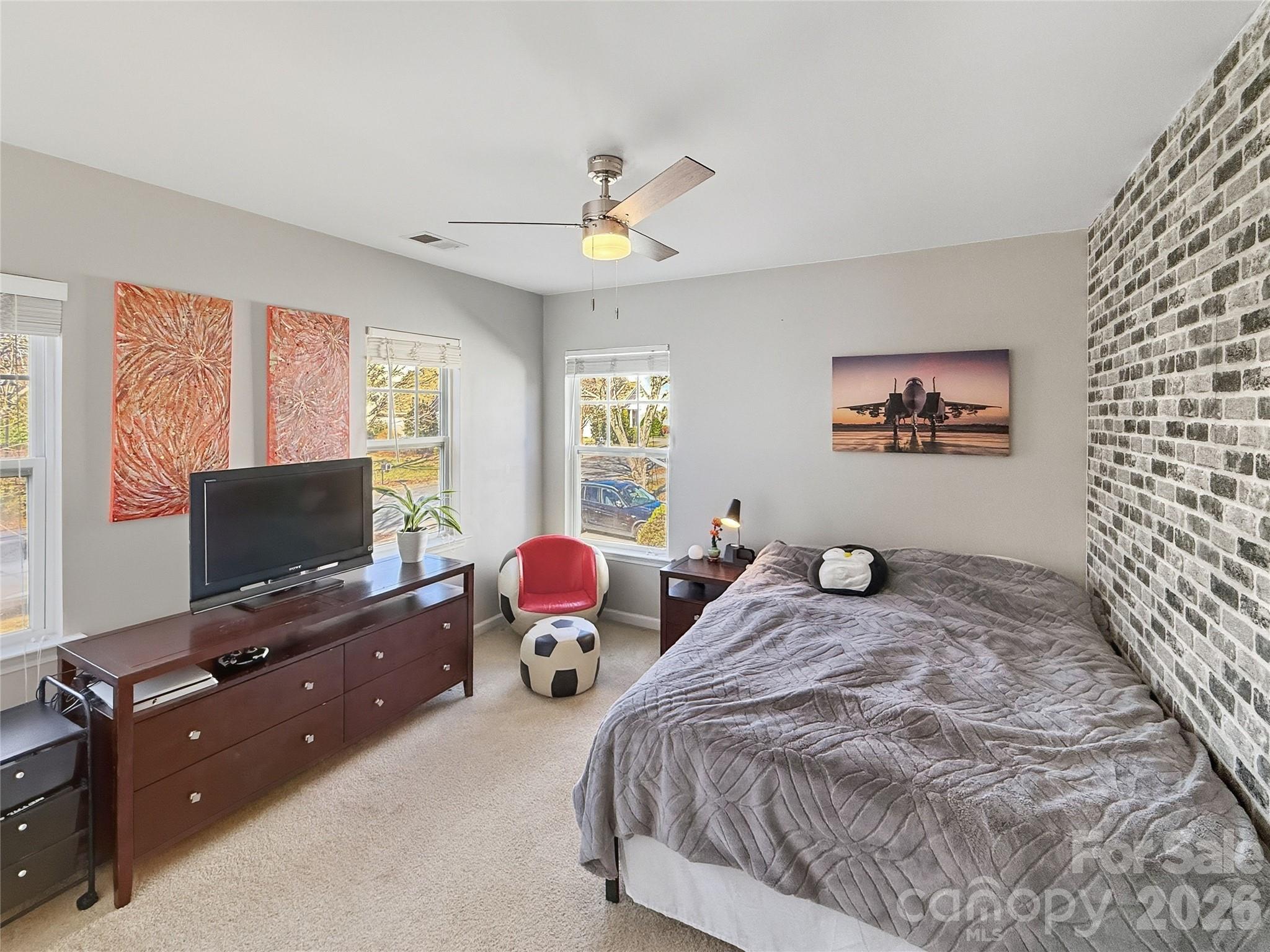 179 Whitley Mills Road, Unit 44 Fort Mill, SC 29708 - Photo 17 of 25 a bedroom with a bed and a flat screen tv