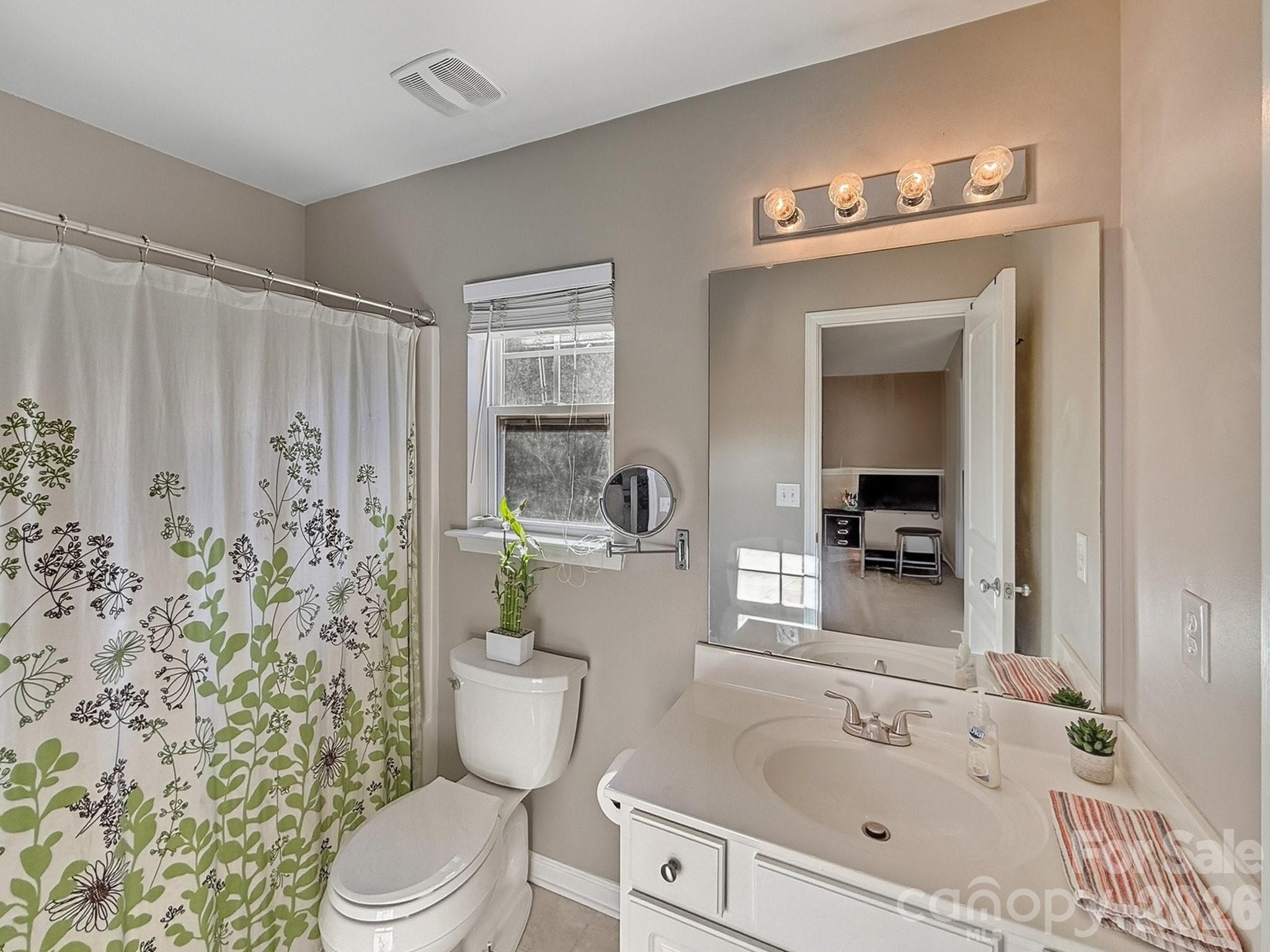 179 Whitley Mills Road, Unit 44 Fort Mill, SC 29708 - Photo 18 of 25 a bathroom with a sink a toilet and shower curtain