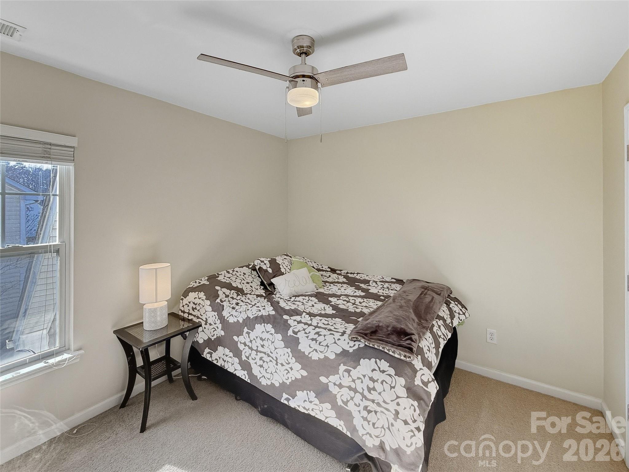 179 Whitley Mills Road, Unit 44 Fort Mill, SC 29708 - Photo 19 of 25 a bedroom with a bed and a window