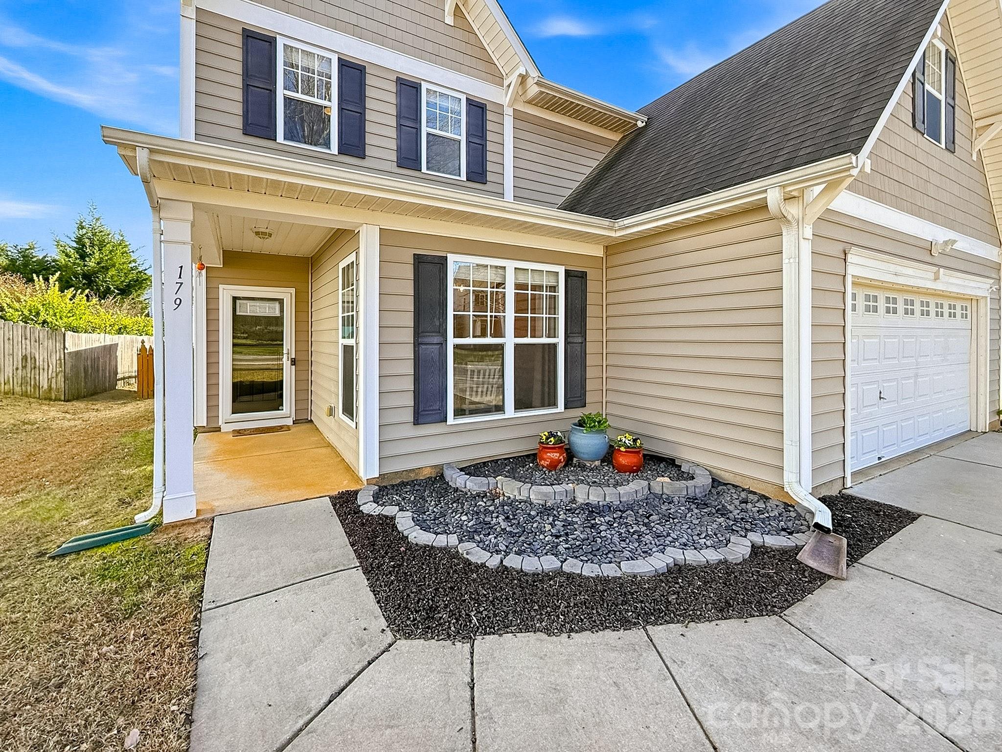 179 Whitley Mills Road, Unit 44 Fort Mill, SC 29708 - Photo 3 of 25 a front view of a house with a floor to ceiling windows and potted plants