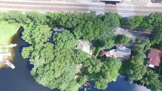 an aerial view of a house with a yard and garden