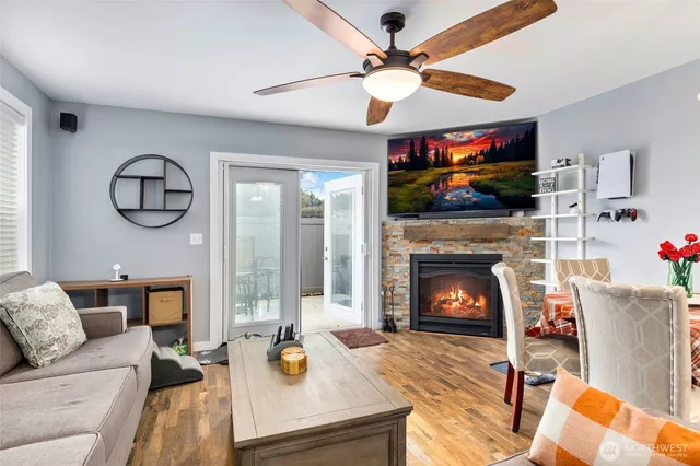 a living room with furniture a flat screen tv and a fireplace