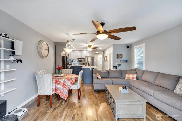 a living room with furniture a clock on wall and a clock