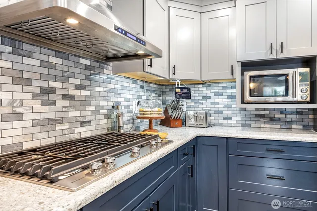 a kitchen with sink stove and cabinets