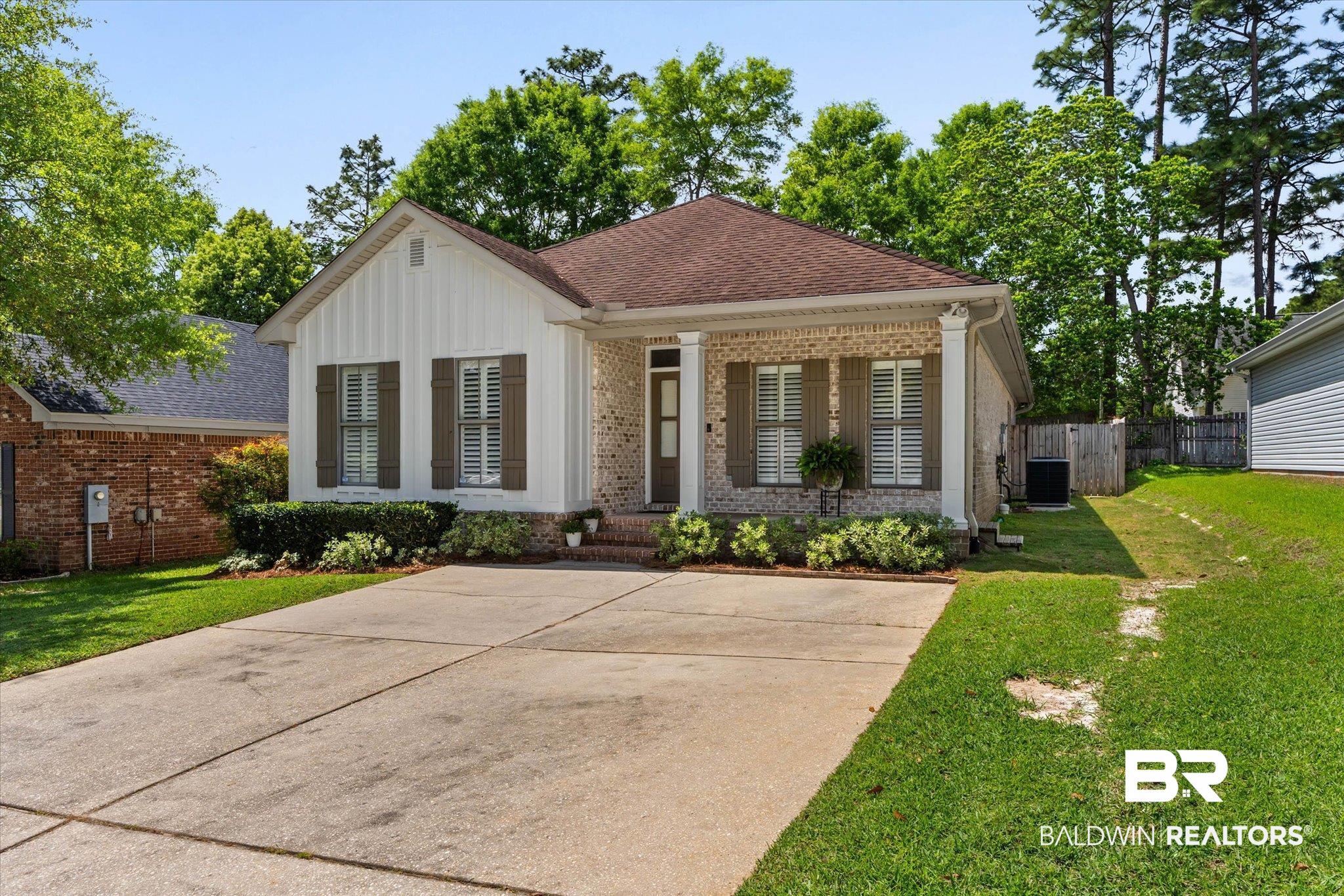 1052 Linlen Avenue Mobile, AL 36609 - Photo 21 of 22 View of front of house featuring brick siding, roof with shingles, and board and batten siding