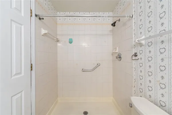 a bathroom with a shower curtain and a toilet