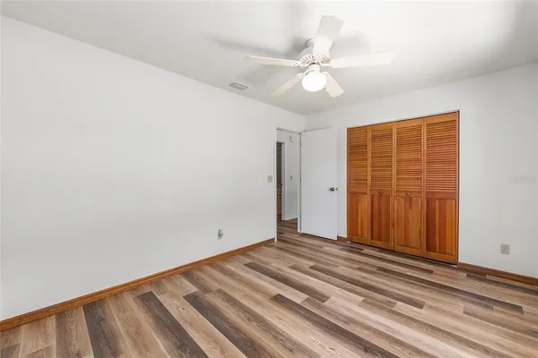 a view of a livingroom with wooden floor and closet area