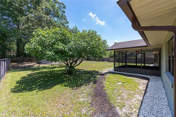 a view of swimming pool with a table and chairs under an umbrella