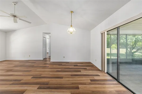 a view of a room with window wooden floor and windows