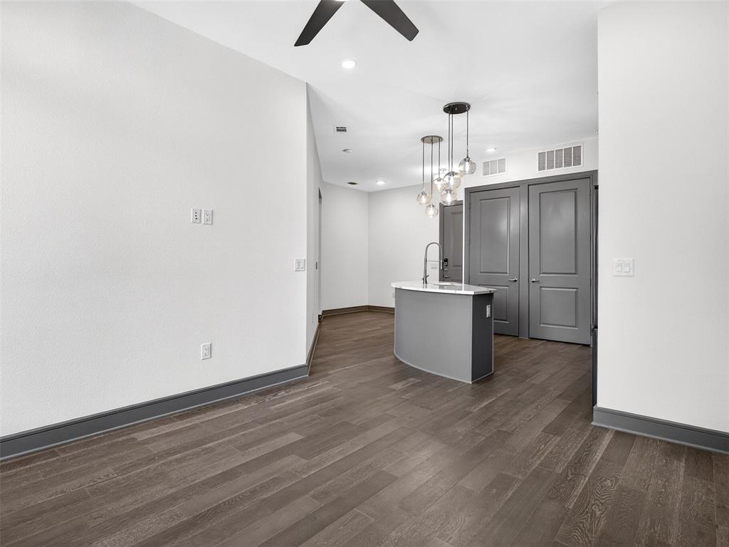 2700 Old Denton Road, Unit 3370 Carrollton, TX 75007 - Photo 10 of 35 an empty room with wooden floor and ceiling fan