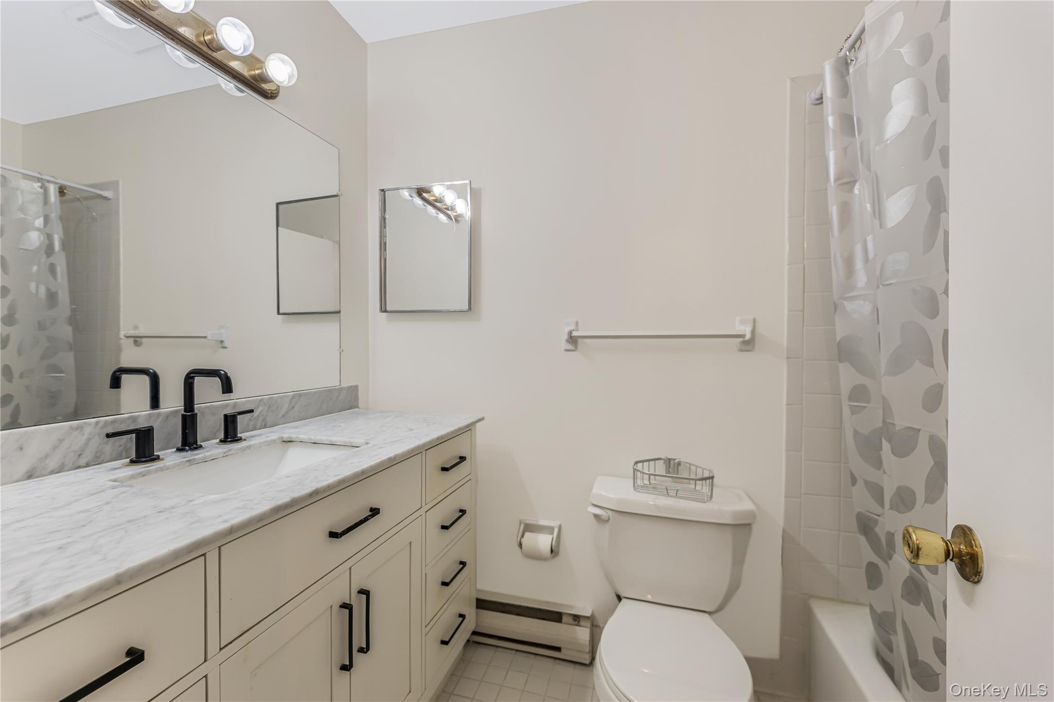 914 Old Country Road Elmsford, NY 10523 - Photo 15 of 21 a bathroom with a granite countertop toilet sink and mirror
