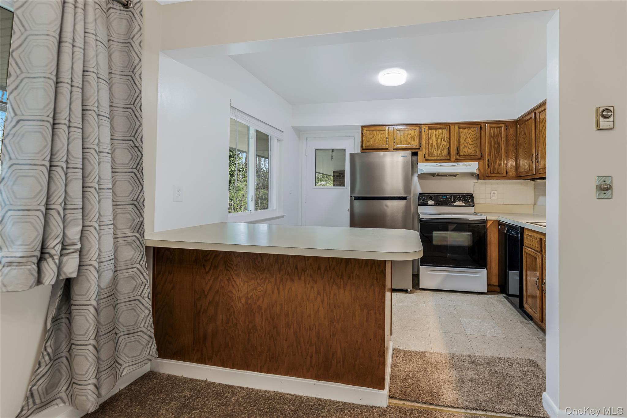 914 Old Country Road Elmsford, NY 10523 - Photo 6 of 21 a kitchen with stainless steel appliances granite countertop a sink and a refrigerator