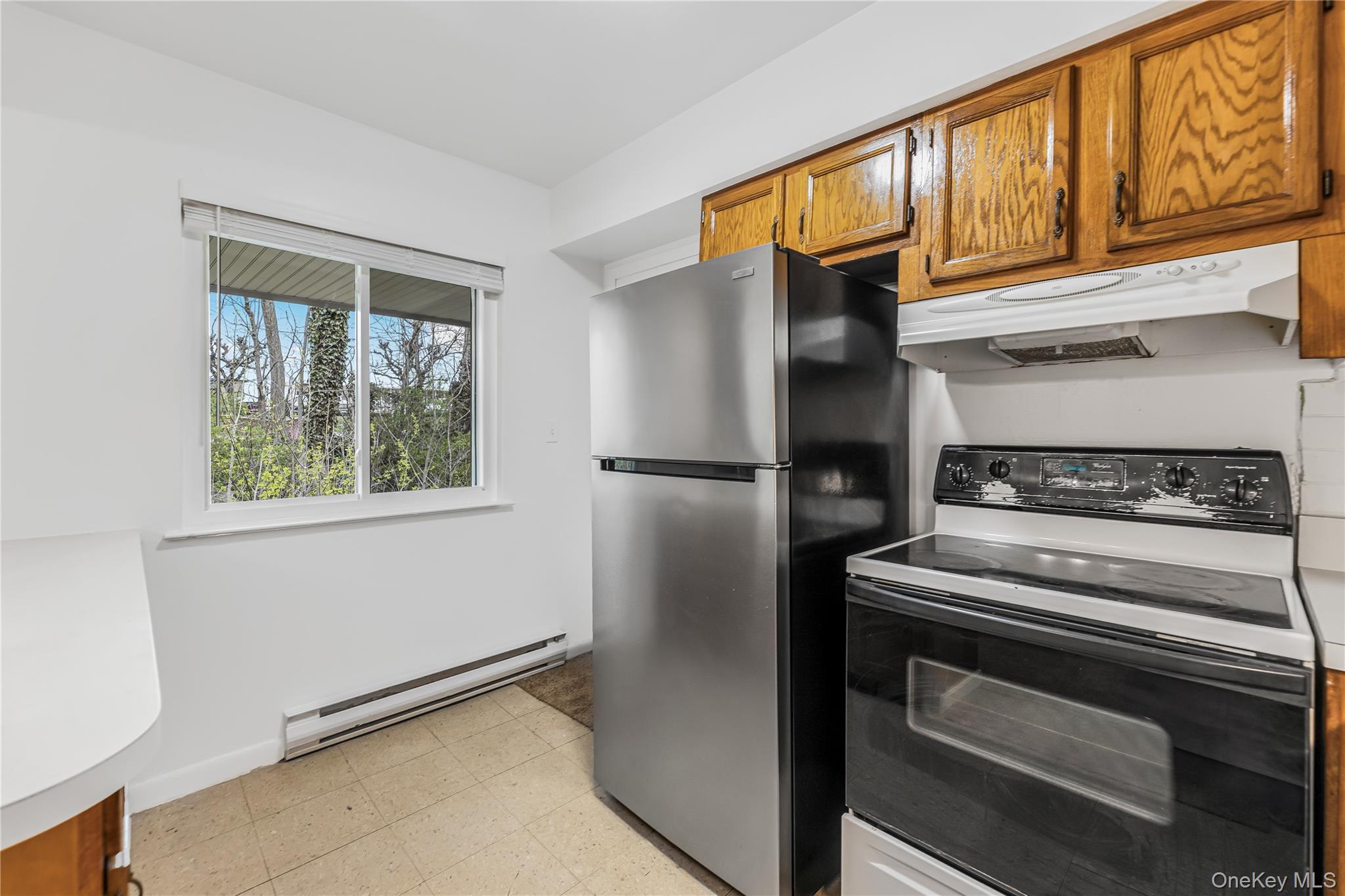 914 Old Country Road Elmsford, NY 10523 - Photo 8 of 21 a kitchen with stainless steel appliances granite countertop a refrigerator and a stove top oven