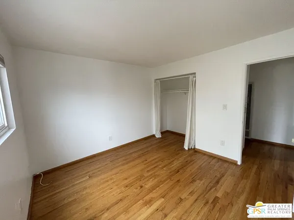 an empty room with wooden floor