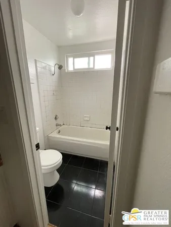 a bathroom with a toilet and a sink