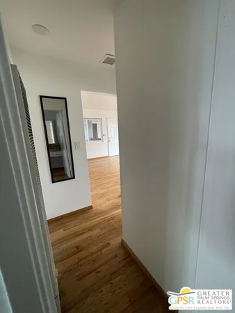 a view of hallway with wooden floor