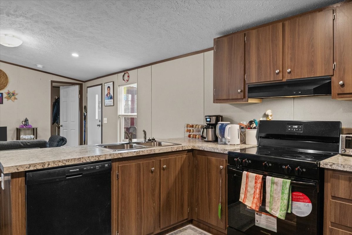 316 Friendship Drive Tennessee Ridge, TN 37178 - Photo 11 of 28 a kitchen with stainless steel appliances granite countertop a sink stove and cabinets