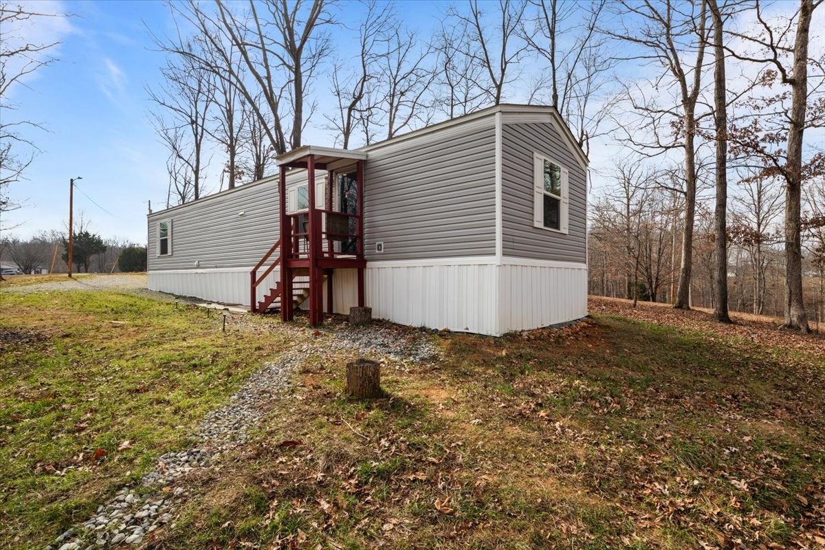 316 Friendship Drive Tennessee Ridge, TN 37178 - Photo 4 of 28 a view of a house with backyard and trees