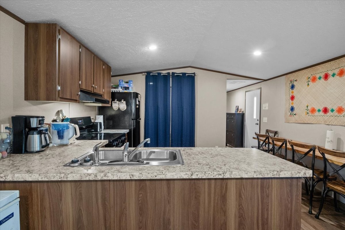 316 Friendship Drive Tennessee Ridge, TN 37178 - Photo 8 of 28 a kitchen with kitchen island granite countertop a sink and refrigerator