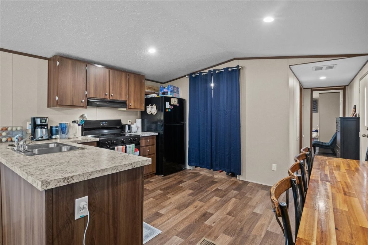 316 Friendship Drive Tennessee Ridge, TN 37178 - Photo 9 of 28 a kitchen with stainless steel appliances granite countertop a sink refrigerator and cabinets