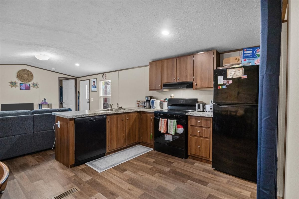 316 Friendship Drive Tennessee Ridge, TN 37178 - Photo 10 of 28 a kitchen with stainless steel appliances granite countertop a refrigerator and a stove top oven