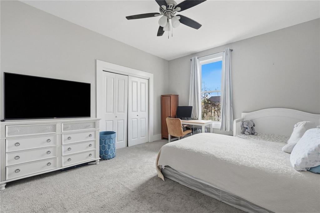 18 Butler Street Rome, GA 30161 - Photo 12 of 26 a bedroom with a large bed and a flat screen tv