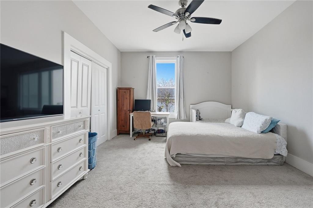 18 Butler Street Rome, GA 30161 - Photo 13 of 26 a spacious bedroom with a bed and a flat screen television