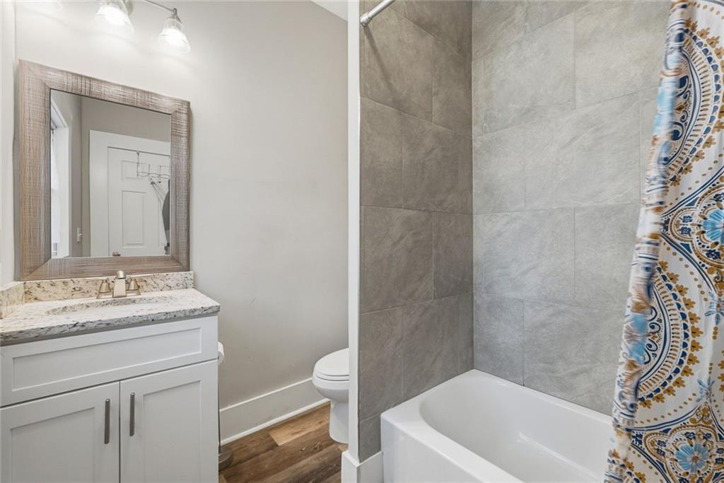 18 Butler Street Rome, GA 30161 - Photo 14 of 26 a bathroom with a sink a toilet and shower