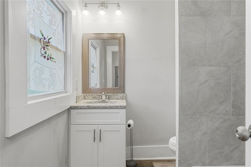 18 Butler Street Rome, GA 30161 - Photo 15 of 26 a bathroom with a sink a mirror and a shower