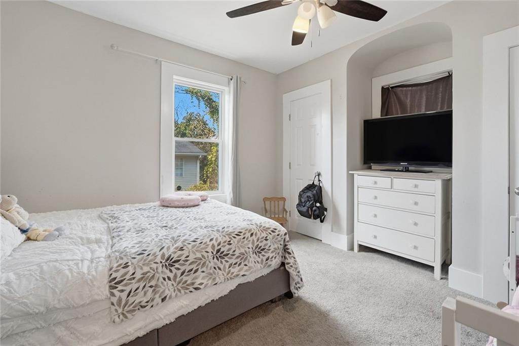 18 Butler Street Rome, GA 30161 - Photo 17 of 26 a bedroom with a bed and a flat screen tv