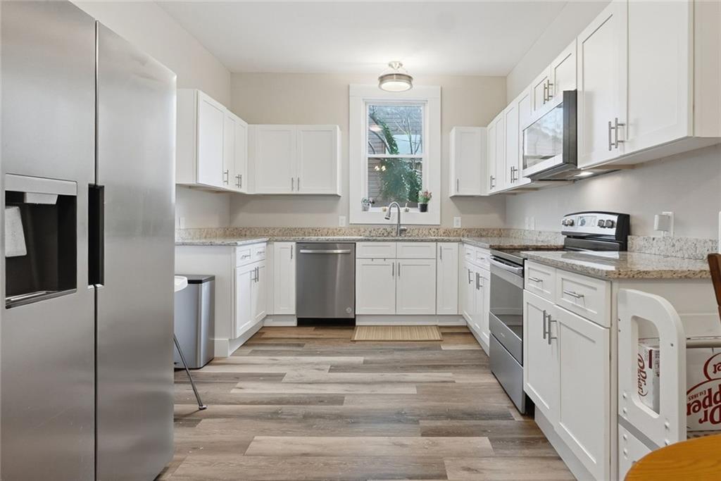 18 Butler Street Rome, GA 30161 - Photo 7 of 26 a kitchen with stainless steel appliances granite countertop a stove a sink and a refrigerator