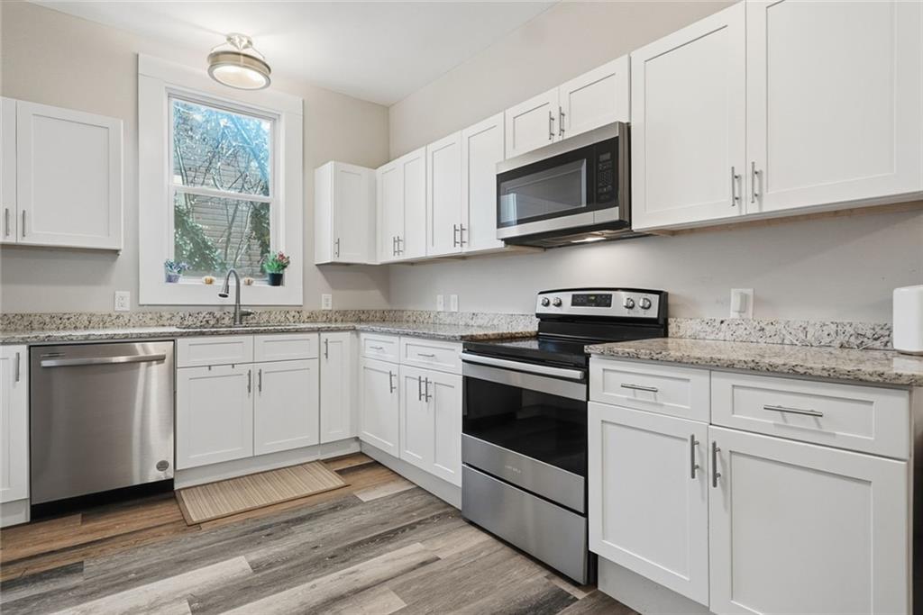18 Butler Street Rome, GA 30161 - Photo 8 of 26 a kitchen with white cabinets appliances and a window
