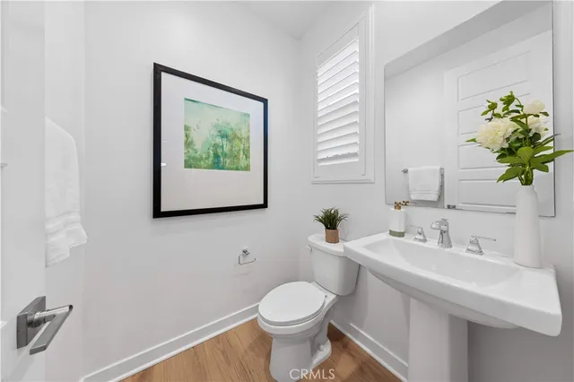 a bed sitting in a bedroom next to a window with potted plant