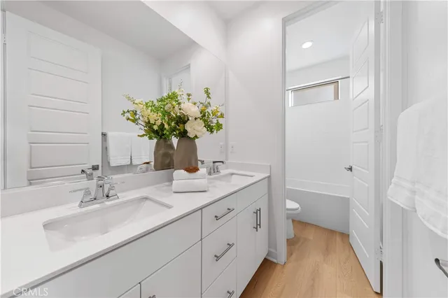a white toilet sitting next to a white tub