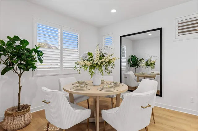a large white kitchen with stainless steel appliances kitchen island granite countertop a sink stove and cabinets