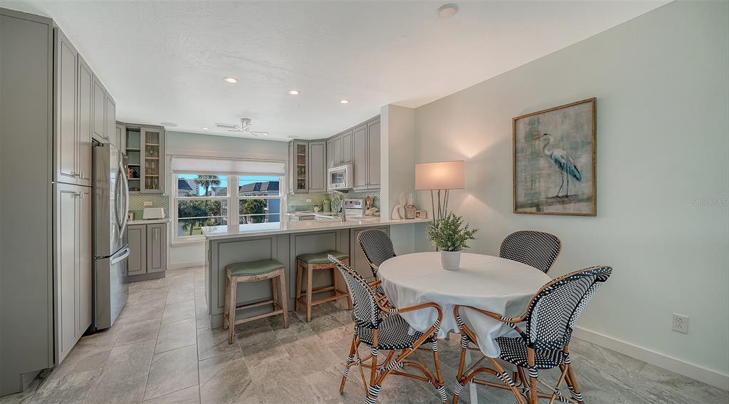 4440 Exeter Drive, Unit 301 Longboat Key, FL 34228 - Photo 11 of 72 a dining room with furniture and window