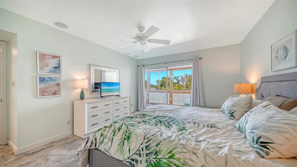 4440 Exeter Drive, Unit 301 Longboat Key, FL 34228 - Photo 14 of 72 a bedroom with a bed a dresser and a window