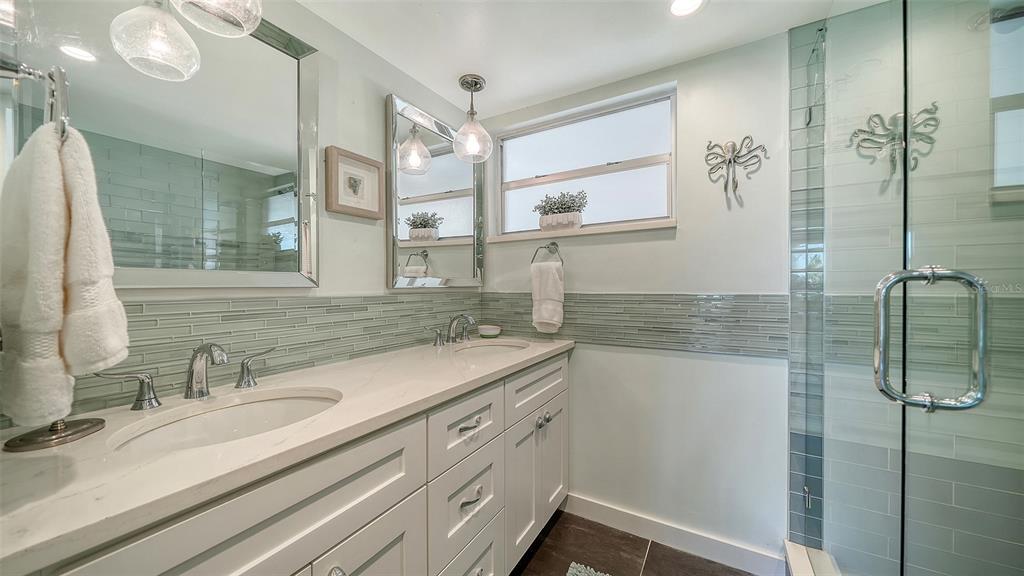 4440 Exeter Drive, Unit 301 Longboat Key, FL 34228 - Photo 15 of 72 a bathroom with a sink and a mirror